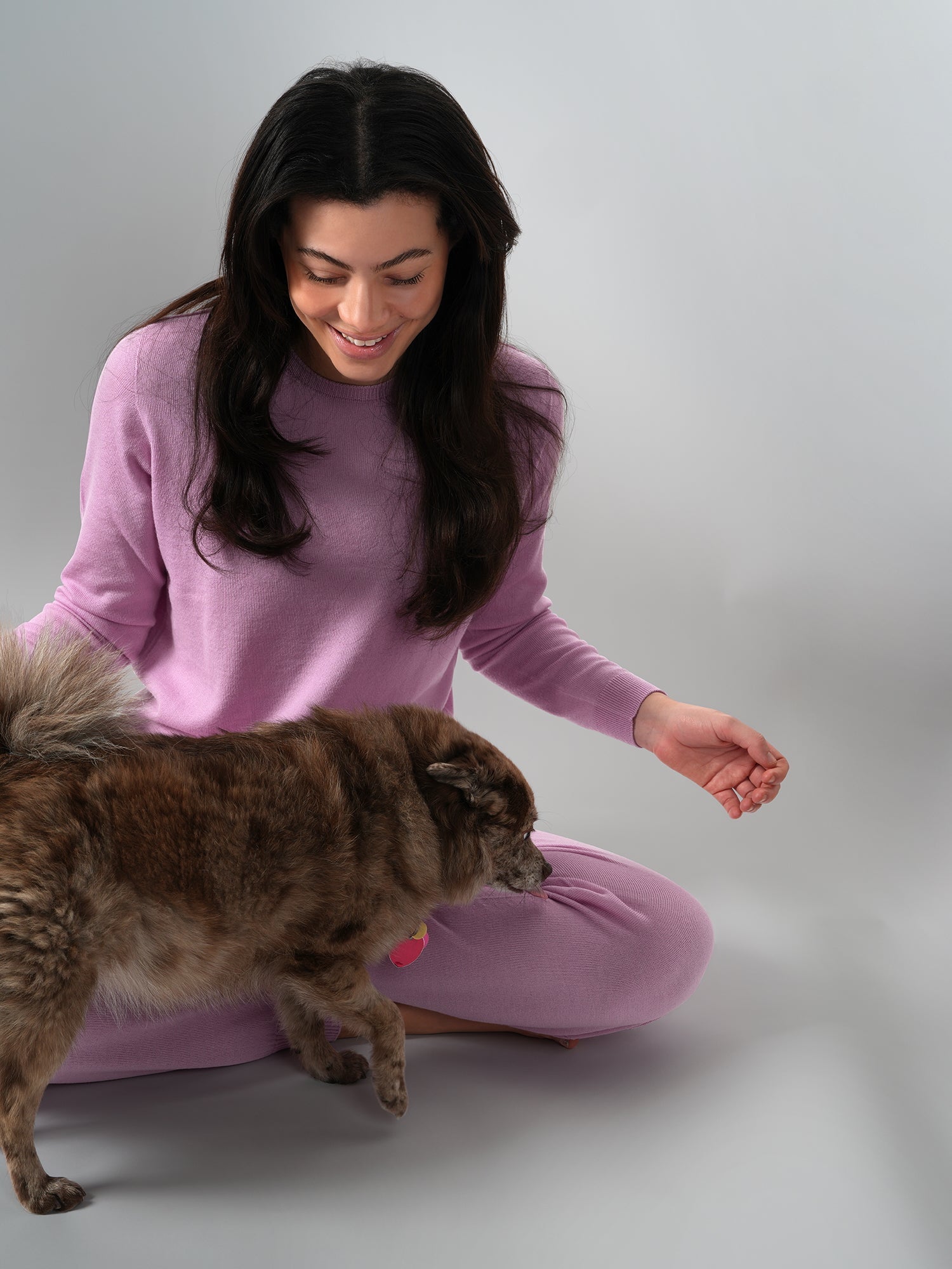 Girl with dog wearing pink sweater set